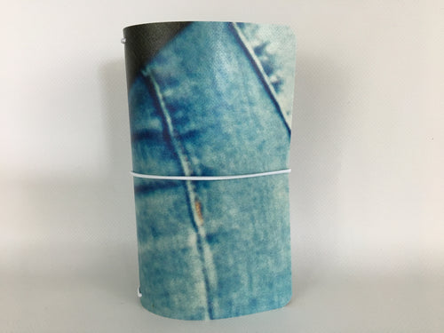 Field Note size travelers notebook cover with a denim blue jeans image from a billboard advertising The Wizarding World of Harry Potter at Universal Studios Hollywood.