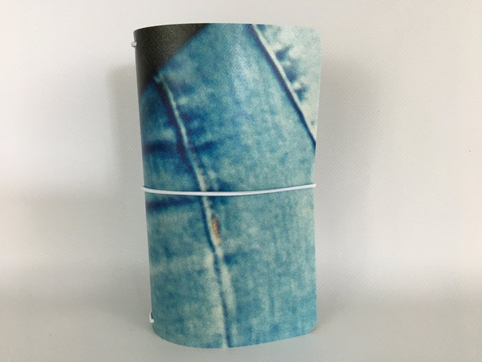 Field Note size travelers notebook cover with a denim blue jeans image from a billboard advertising The Wizarding World of Harry Potter at Universal Studios Hollywood.