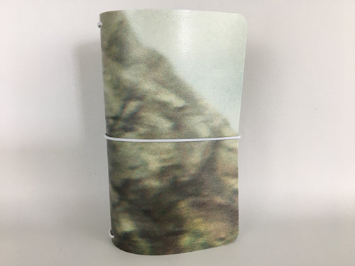 Pocket size Moleskine notebook cover made from fused billboard vinyl with an abstract stone-like pattern.