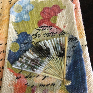 Printed paper transferred to canvas with an Asian fan embellishment.