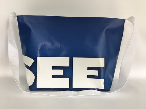Billboard vinyl tote bag, dark blue with large white typography.
