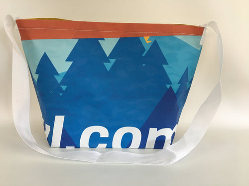 Billboard vinyl tote bag with a pattern of blue evergreen trees.