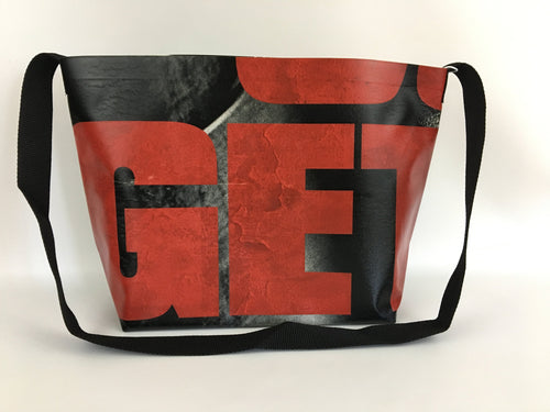 Vinyl tote bag with red typography from a Walking Dead billboard.