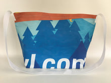 Billboard vinyl tote bag with a pattern of blue evergreen trees.